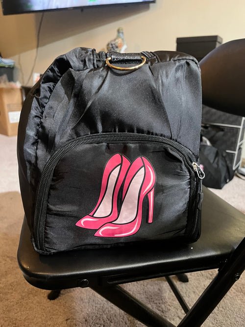 Black bag with pink high-heel graphic and front zippered pocket
